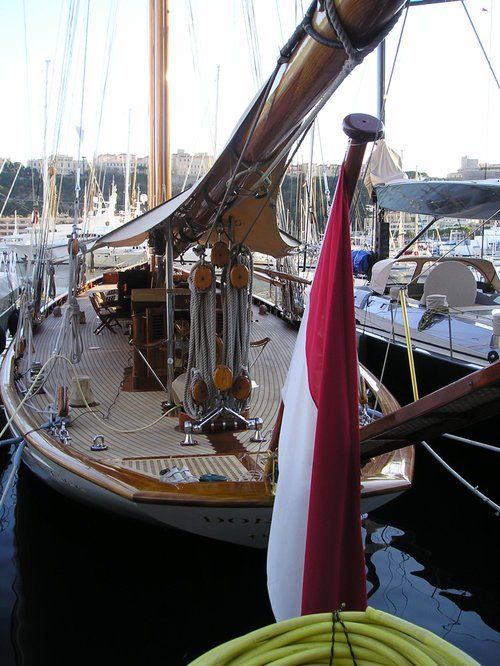 A boat with a red white and blue flag on the mast