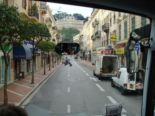 A white van is parked on the side of the road