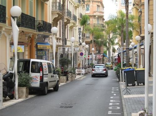 A white van is parked on the side of the road