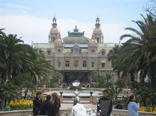 A group of people standing in front of a large building