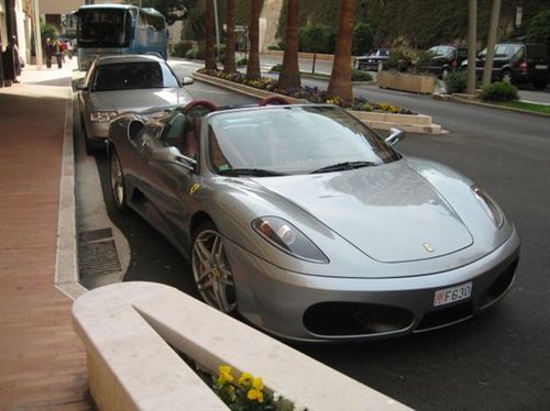 A silver sports car is parked on the side of the road