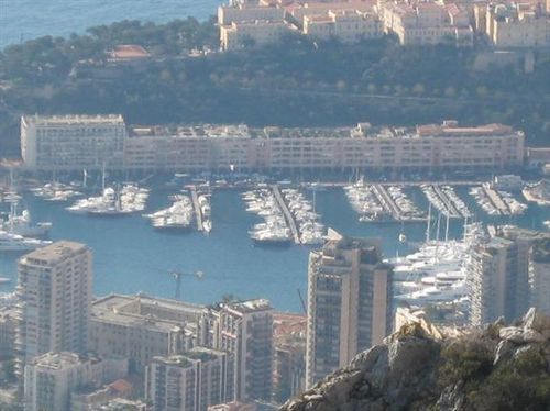 A city with lots of buildings and boats in the water