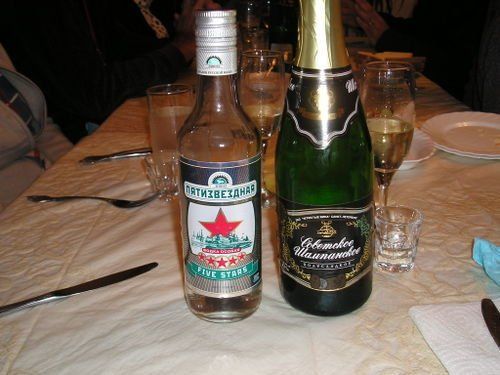 Two bottles of alcohol are sitting on a table