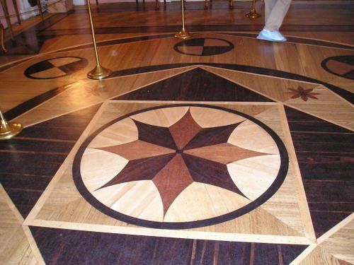 A wooden floor with a star in the center