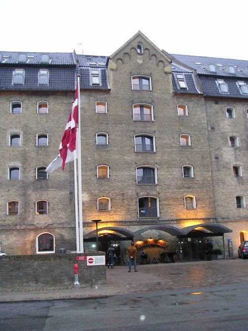 A large building with a red white and blue flag in front of it
