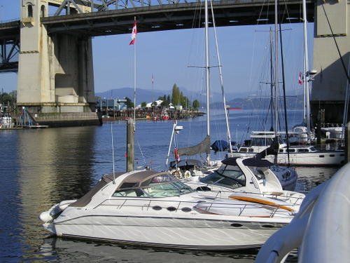A boat is docked under a bridge in the water