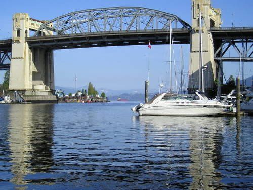 A bridge over a body of water with boats in the water