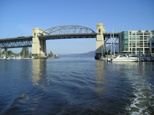 A bridge over a body of water with a building in the background