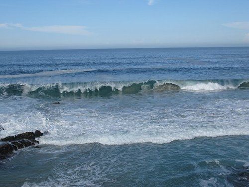 A large body of water with waves crashing on the shore