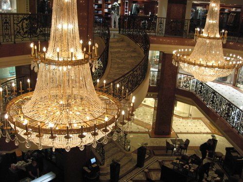 A large chandelier hangs from the ceiling of a building