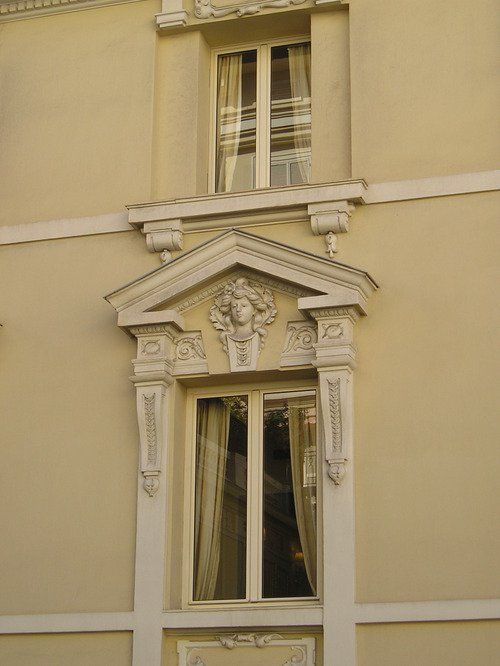 A building with a window and a statue on it