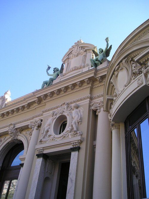 A building with columns and statues on top of it