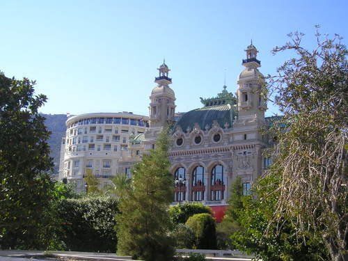 A large building is surrounded by trees and bushes
