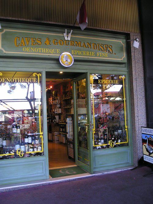 A store front with a sign that says caves & gourmandises