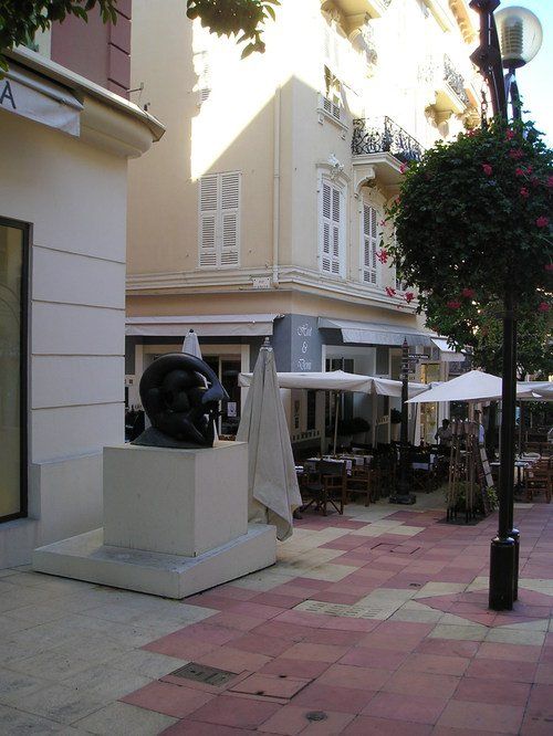 A statue in front of a building with the letter a on it