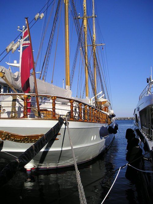 A large sailboat is docked in a harbor
