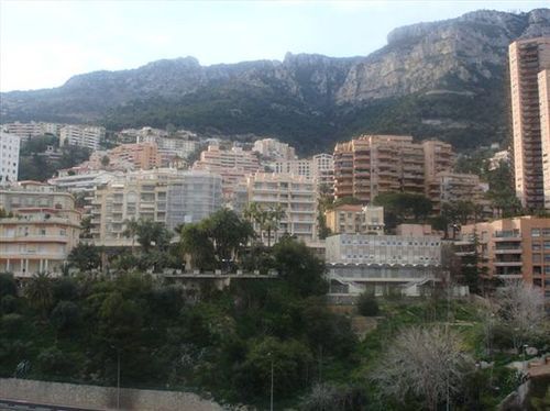 A city with mountains in the background and a lot of buildings