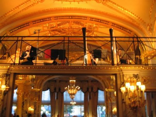 A large room with a balcony and a ceiling