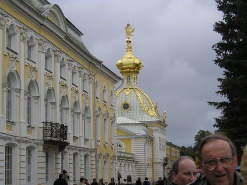 A man stands in front of a building with a dome on top