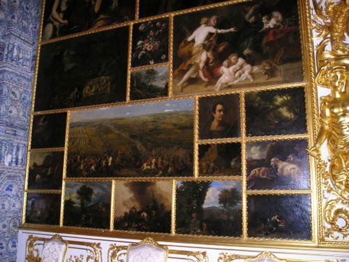 A wall with a lot of paintings on it