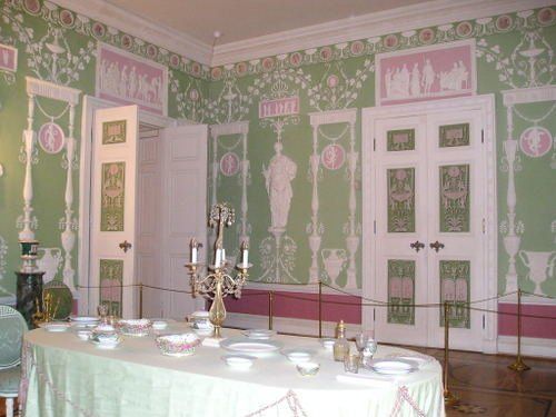 A dining room with a long table and plates on it.