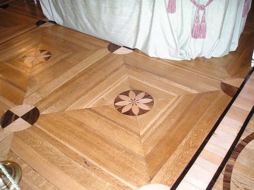 A wooden floor with a flower design on it