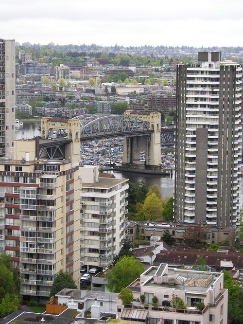 An aerial view of a city with a bridge in the background