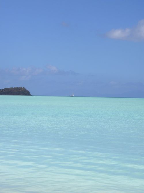 A large body of water with a small island in the distance.