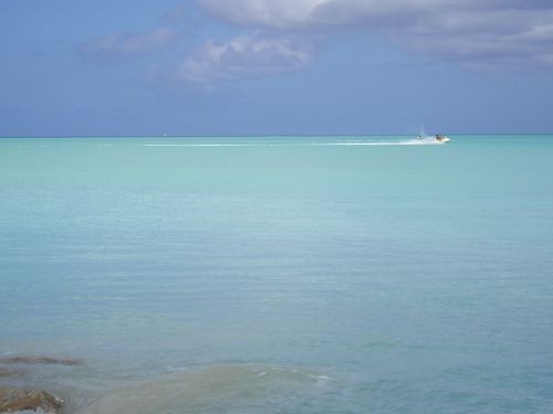 A boat is floating on top of a large body of water.