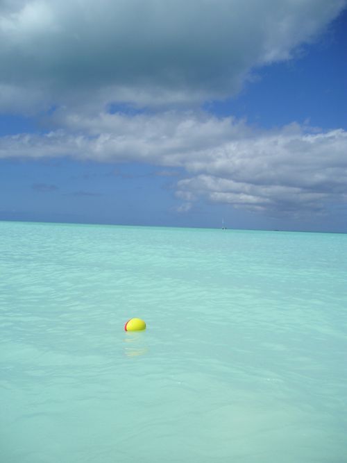 A yellow buoy is floating in the ocean.