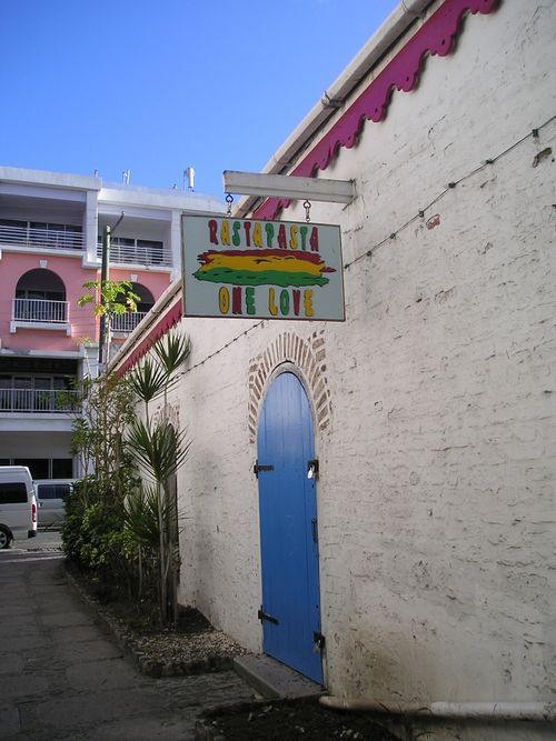 A white building with a sign that says rastafari on it