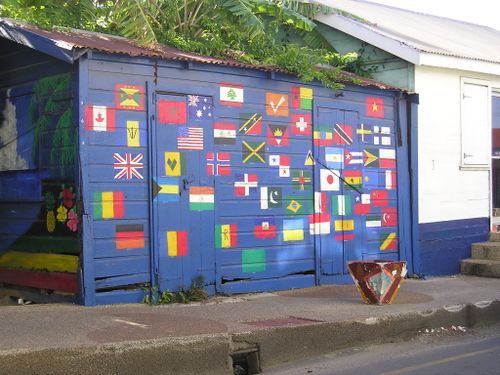 A blue building with a bunch of flags on it