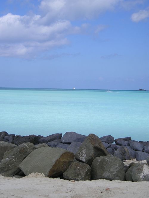 A large body of water with rocks in the foreground