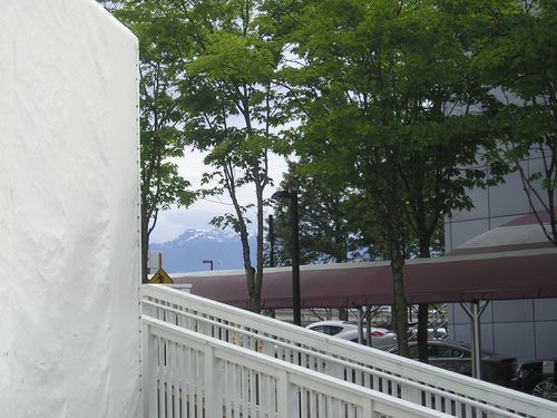 A white ramp leading up to a building with trees in the background