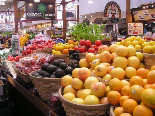 A variety of fruits and vegetables are on display in a grocery store