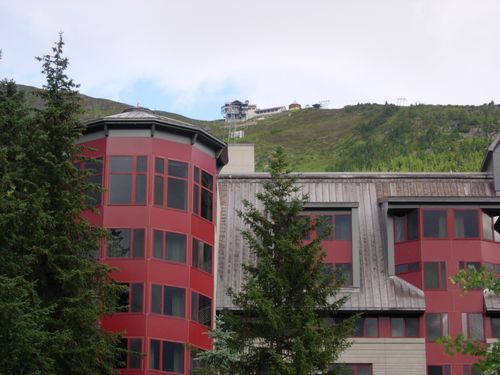 A large red building with a mountain in the background
