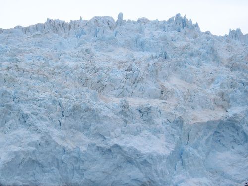 A large pile of snow is sitting on top of a mountain.