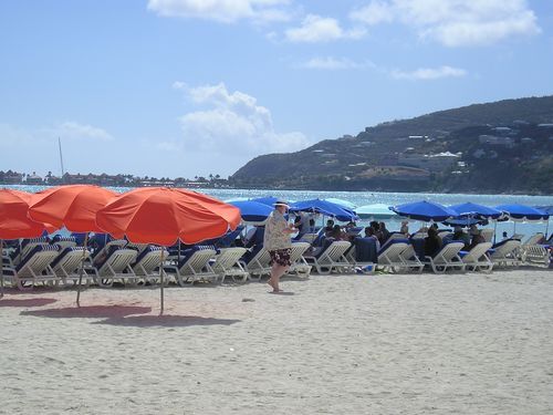 A beach with a lot of chairs and umbrellas