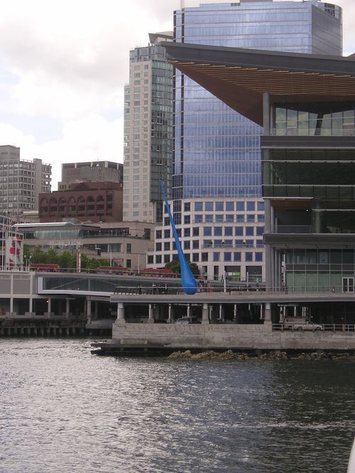 A large building with a blue sculpture in front of it