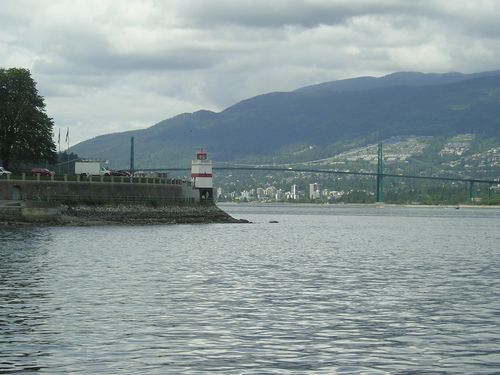 A bridge over a body of water with mountains in the background