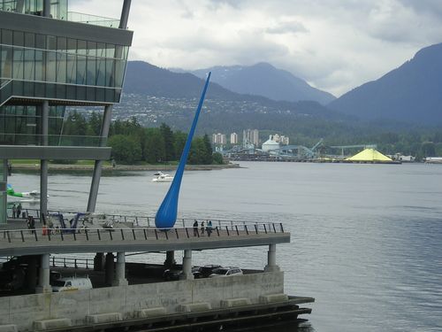 A large blue object is hanging over a body of water
