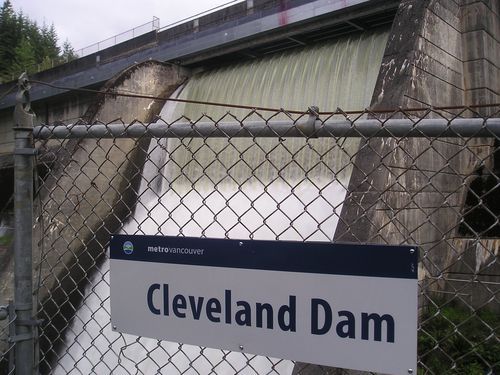 A sign on a chain link fence says cleveland dam