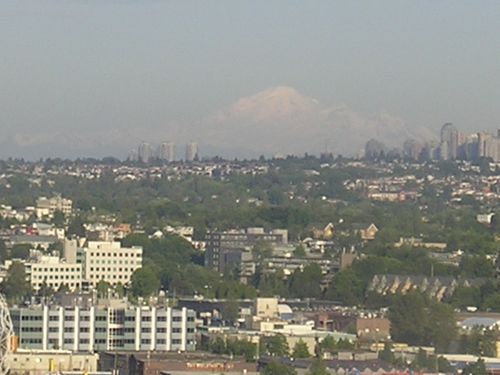 An aerial view of a city with a mountain in the background