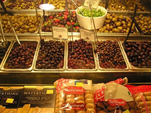 A display case filled with lots of different types of olives