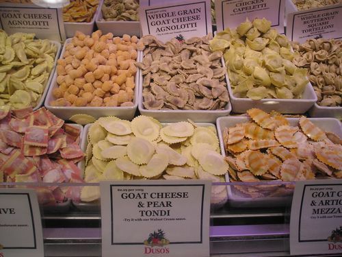 A display of food including goat cheese and pear tondi
