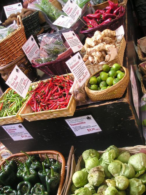 A variety of fruits and vegetables are on display at a market.