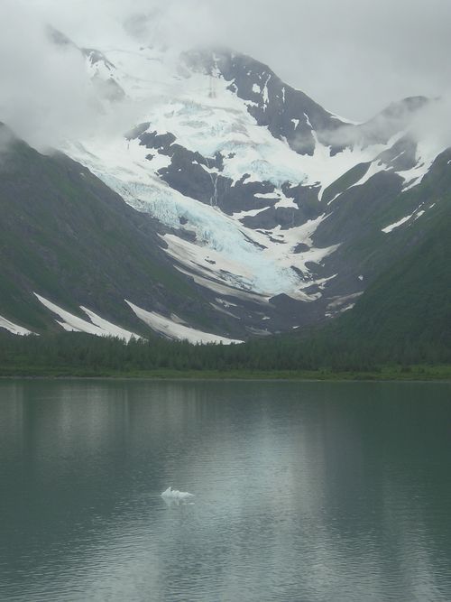 A lake surrounded by snow covered mountains and trees