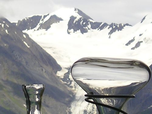 A glass container with a mountain in the background