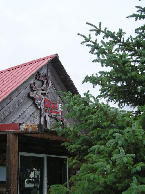 A house with a red roof and a reindeer on it