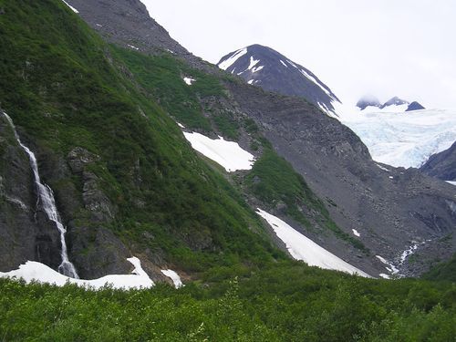 A waterfall runs down the side of a mountain
